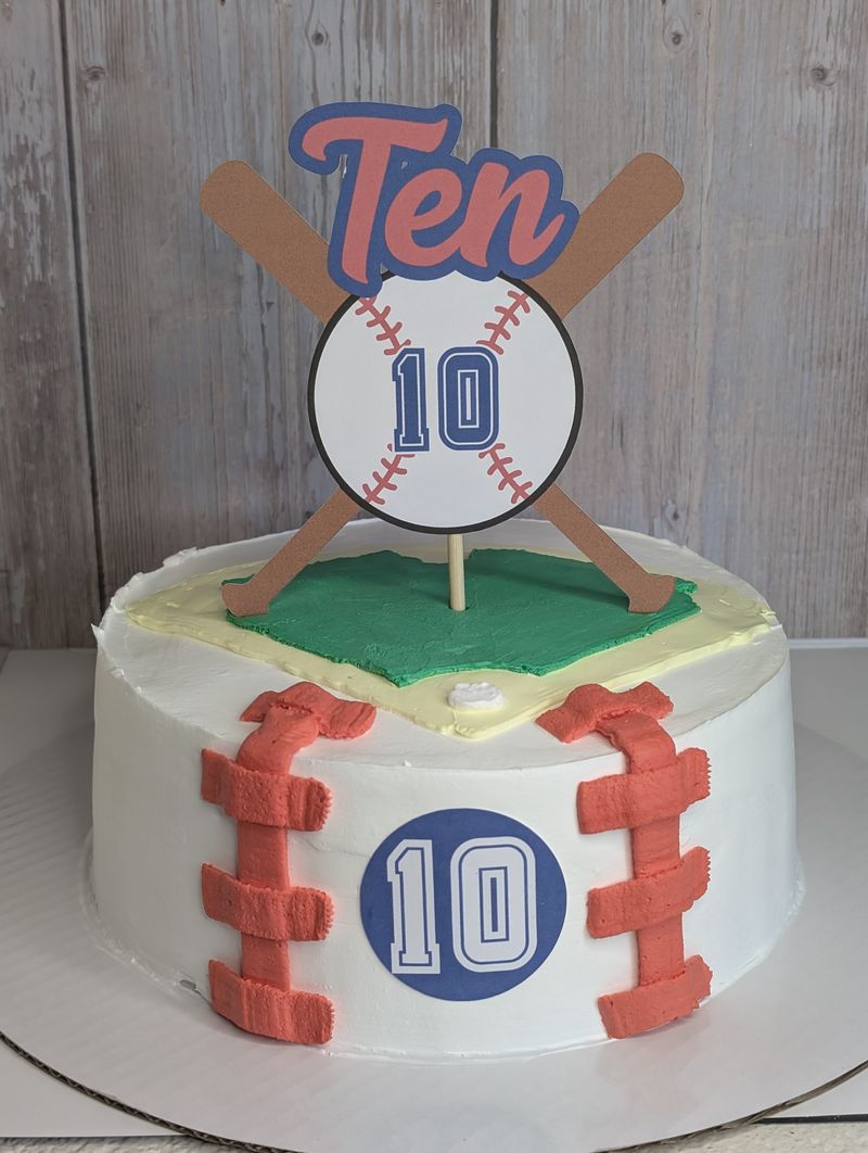 Baseball themed birthday cake topper with the number 10 on a white cake