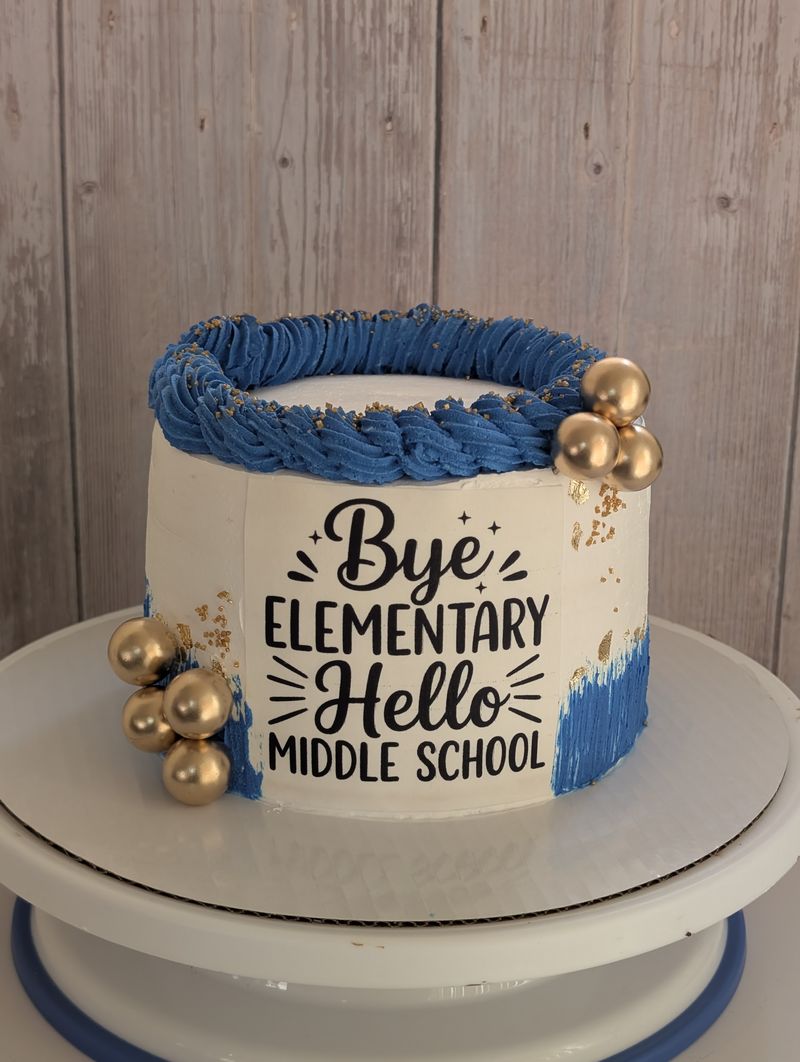 Bye Elementary Hello Middle School graduation cake topper on a blue cake