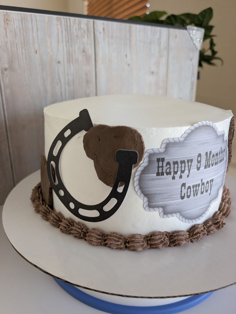 Western cowboy birthday cake topper with a horseshoe design