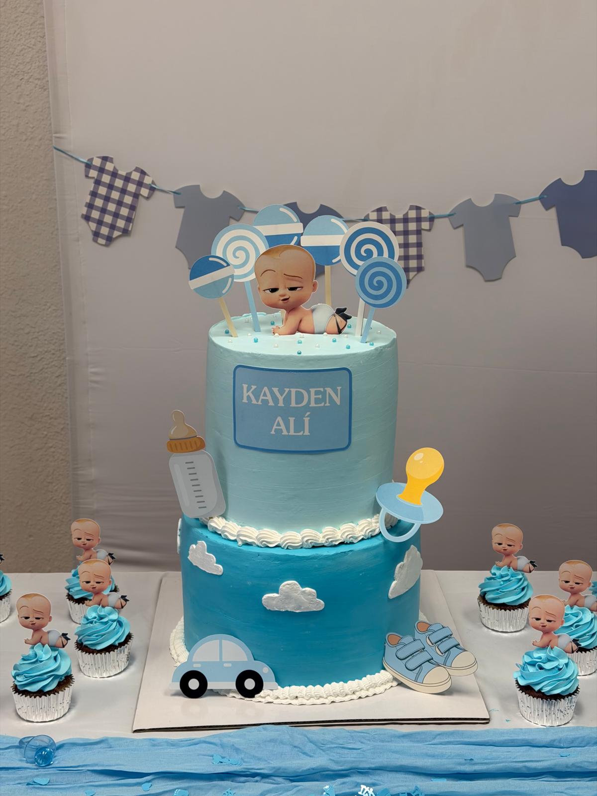 Boss Baby themed baby shower dessert table with custom cake toppers and matching cupcakes made in Las Vegas